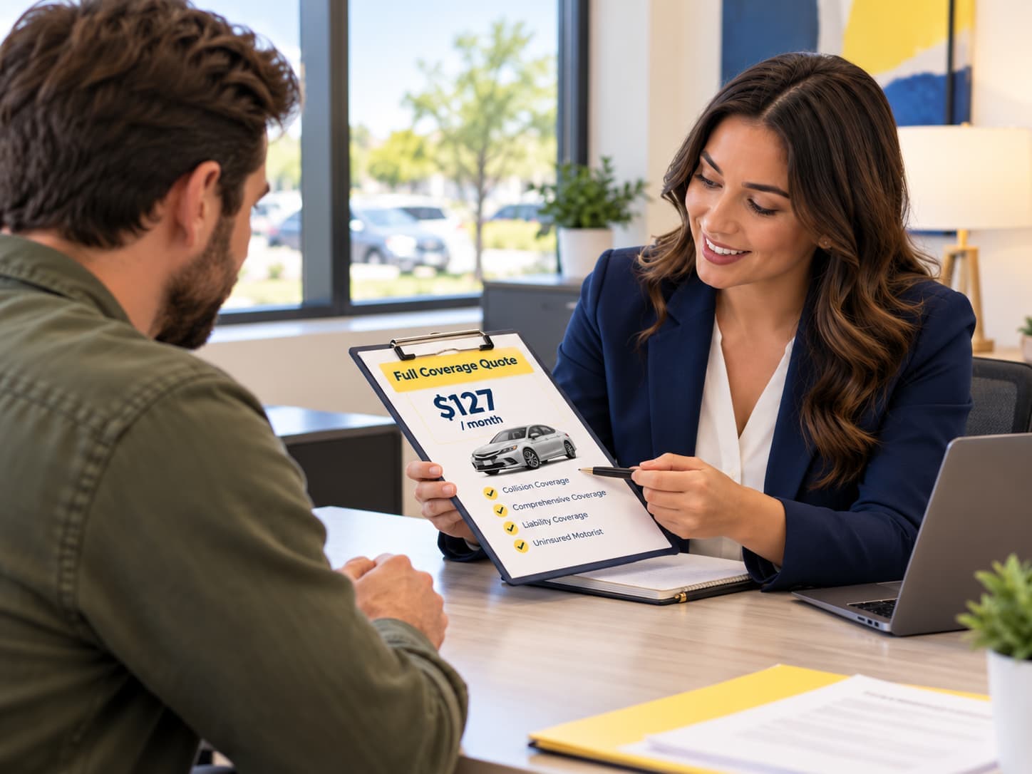 Insurance agent reviewing a full-coverage car insurance quote with a customer in an Oklahoma City office.
